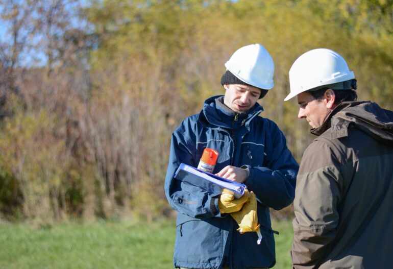 Environmental experts reviewing information in a field