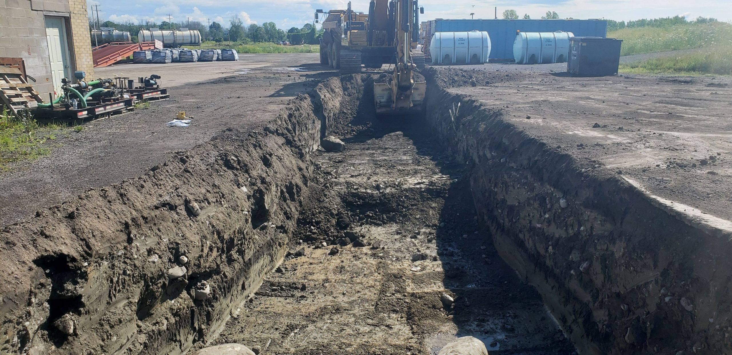Excavated pit with tanks sitting nearby