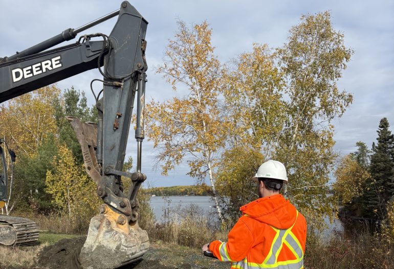 Environmental scientist overseeing a test pitting and on-site screening program.