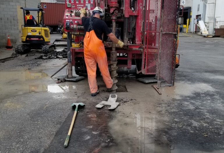 A driller operating a rig in a parking lot