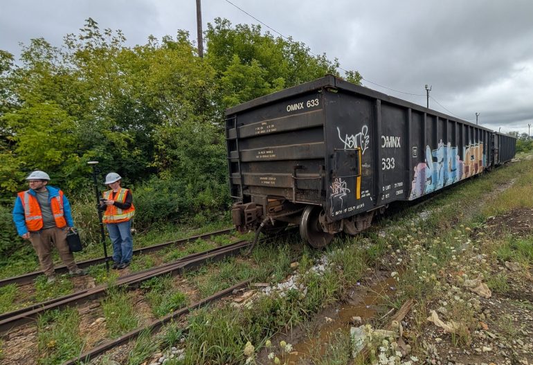 Environmental Scientists Engineers with an RTK on a Rail Line