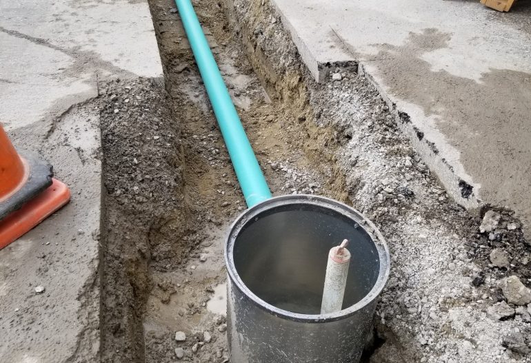 A trench to inject remedial amendments dug in a parking lot